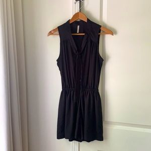 Black sleeveless romper with buttons